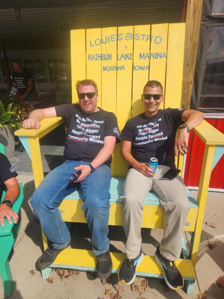 Employees enjoying the sun in the big chair at Lake Rathbun.